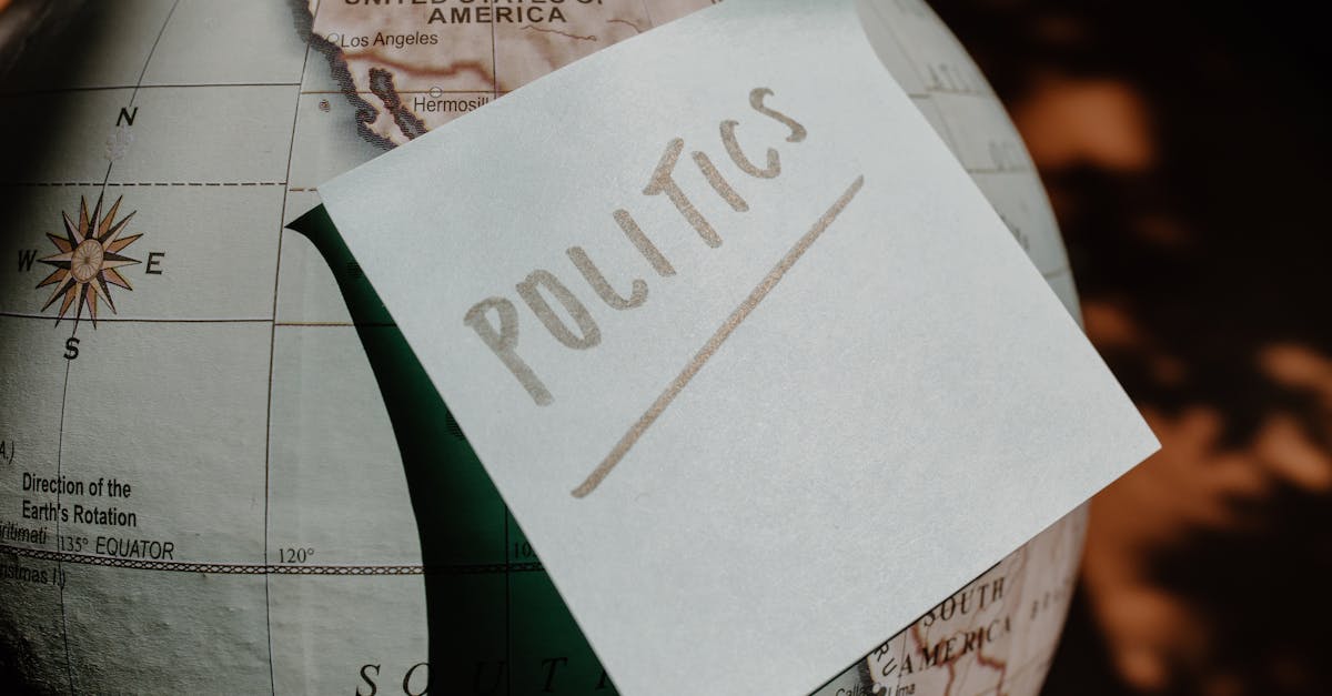 A close-up of a globe with a politics sticky note, symbolizing global political themes.